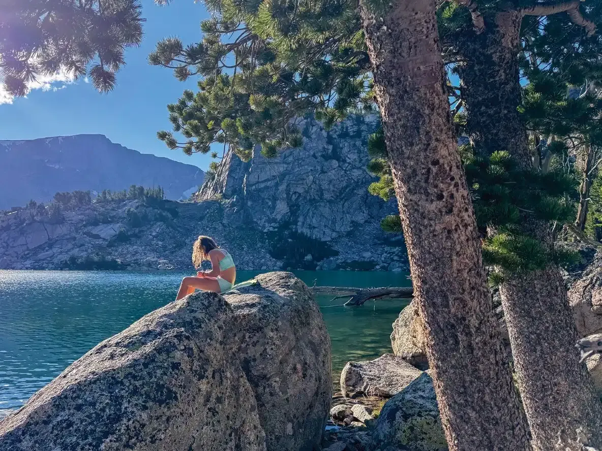 The Shifting Wild of Adventuring with Kids 6 Amelia laying a towel on a rock to warm up after a cold swim