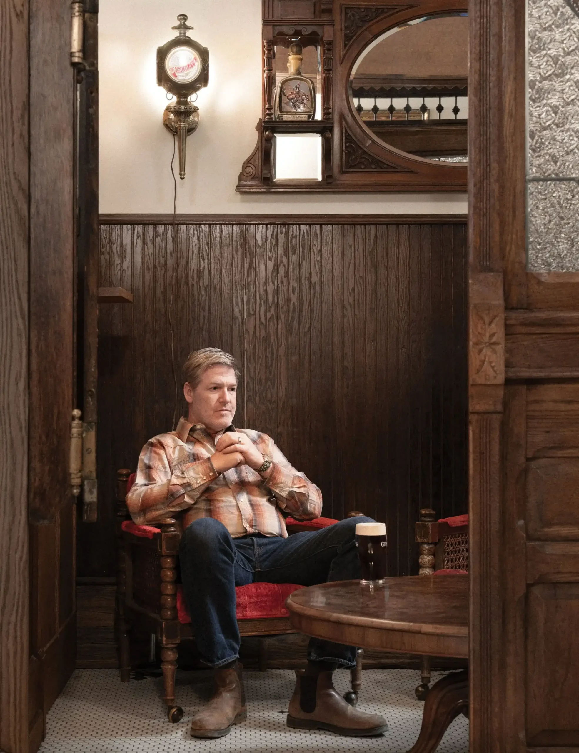 Saloon owner Brett Evje sips a beer in his Irish snug at the new Stockman's Bar