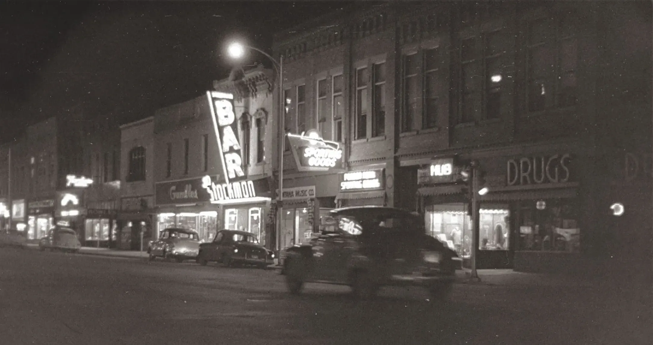 A night shot of Main Street in Bozeman circa 1950 showing the original Stockman Bar